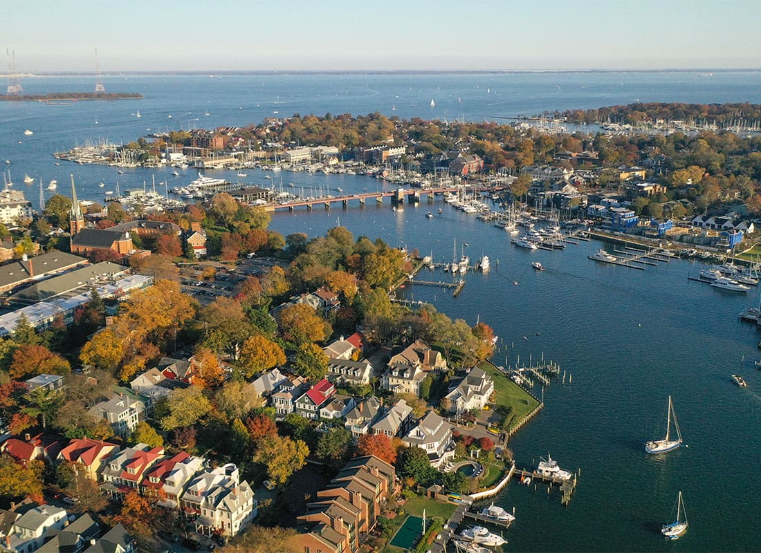 Contact - Aerial View of Coastal Homes and Buildings Surrounded by Colorful Fall Foliage in Annapolis Maryland on a Sunny Day