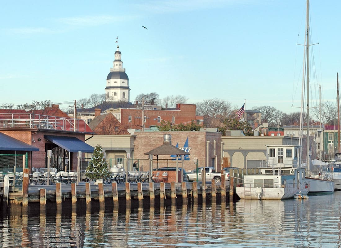 About Our Agency - View of the Harbor with Boats in Annapolis Maryland with Commercial Buildings Against a Clear Blue Sky